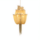 The Mireya 8 Light Metal Chain Veil Chandelier in gold features layered, wavy golden-yellow translucent shades and cascading metallic fringe on brass chains—an exquisite luxury lighting piece against a white background.