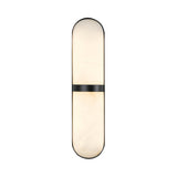 The Zantari LED Cylinder Alabaster Wall Light features an elongated oval shape, diffused soft white light, rounded ends, and a matte black accent band—all crafted from refined Spanish alabaster.