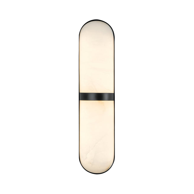 The Zantari LED Cylinder Alabaster Wall Light features an elongated oval shape, diffused soft white light, rounded ends, and a matte black accent band—all crafted from refined Spanish alabaster.