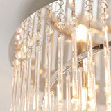 Close-up of the Vivienne 4 Light Flush Ceiling Light in polished chrome, showing glass rod drops and crystal beads catching illuminated bulbs.