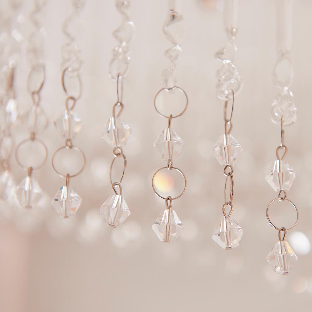 Close-up of clear crystal bicone beads and rings on the Vivienne 4 Light Flush Ceiling Light in polished chrome, set against a soft neutral background.