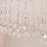 Close-up of clear crystal bicone beads and rings on the Vivienne 4 Light Flush Ceiling Light in polished chrome, set against a soft neutral background.