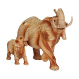 Elephant & Calf wood effect resin figurine in brown, mother with curved tusks mid-stride beside calf, both trunks raised, wood-grain finish on plain white background.