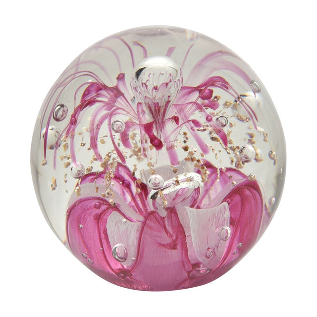 Round glass paperweight with a pink floral design, ruffled petals at the base, fine tendrils, gold flecks, and scattered air bubbles, set against a plain white background.