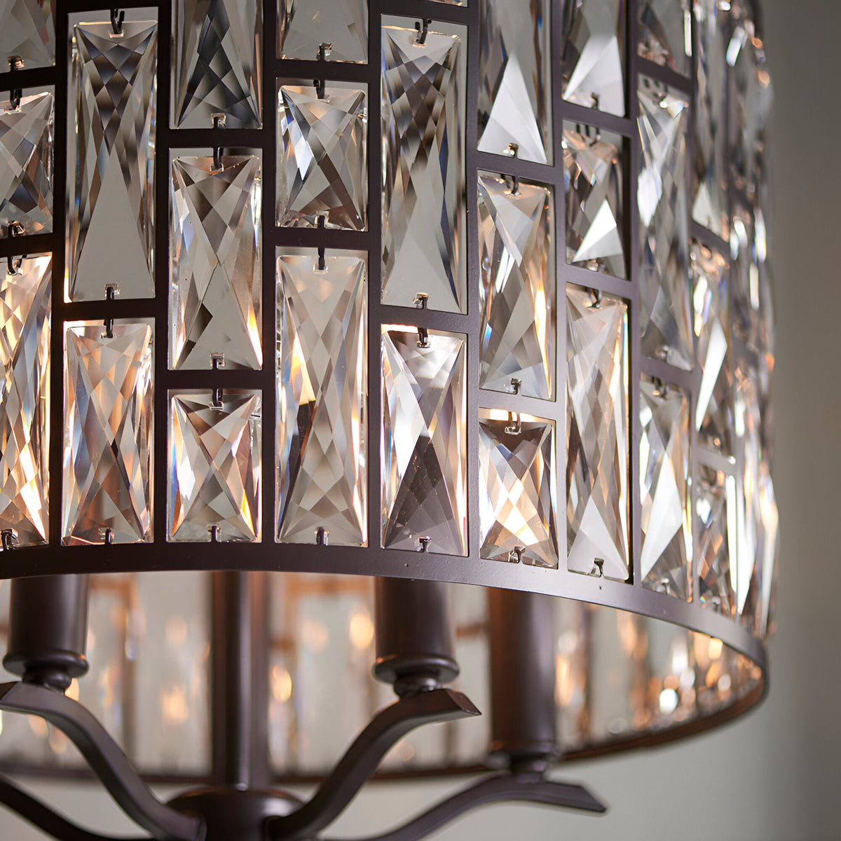 Close-up of Endon Aldwick 5 Light Pendant in dark bronze, showing tiered faceted K5 glass crystals set within a geometric bronze frame.