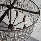 Close-up view of the Endon Aldwick 8 Light Pendant in dark bronze, showing tiered faceted crystal panels, candle-style E14 lamps and metal frame.