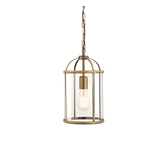 Caldbury Pendant Light in brass, a single-light lantern-style fixture with clear glass panels and E27 bulb, hung from a chain, on white background.