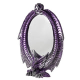 Oval wall mirror framed by a winged resin dragon in metallic purple with silver highlights, crouching at the base with wings curving up to meet at the top, shown on a white background.