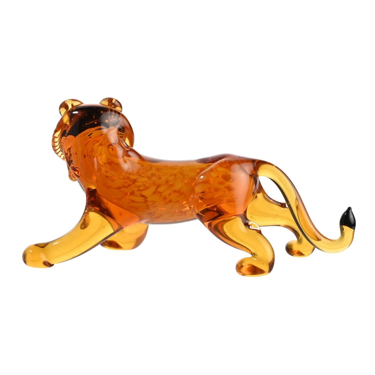 Miniature glass lion figurine in mottled orange glass with paler golden legs and tail, black tail tip, four-legged pose on a plain white background.