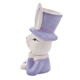 Ceramic planter shaped as a white bunny in a purple top hat and jacket, paw raised to chin, long ears framing the open-topped hat, on a plain white background.