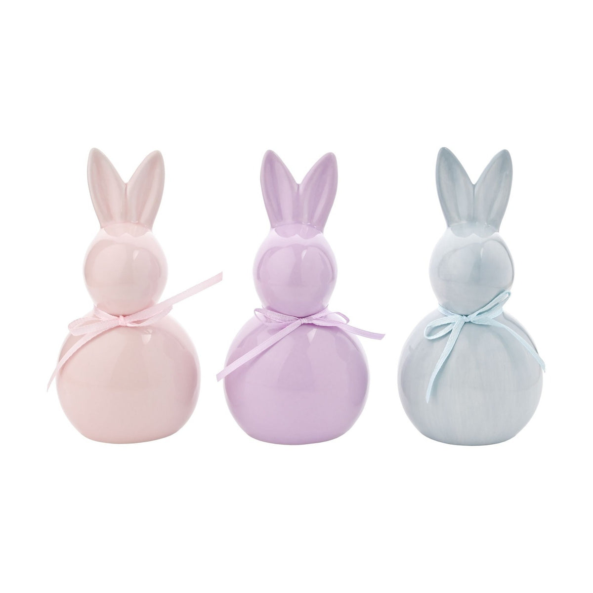 Set of 3 ceramic Easter bunny figurines in pale pink, lilac and grey-blue, each with a glossy glaze, rounded body, tall ears and a matching ribbon bow, shown on a plain white background.