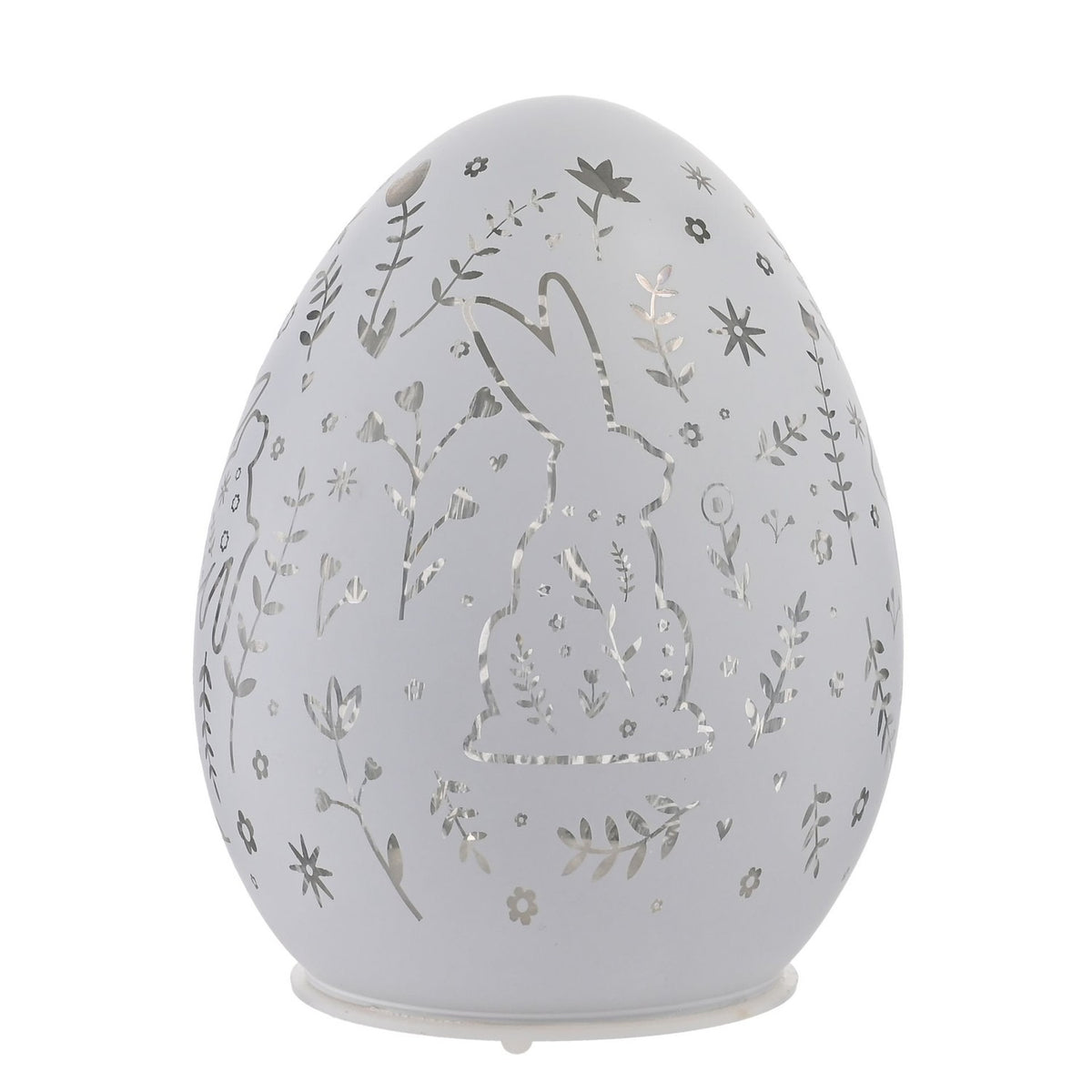 White glass Easter egg LED light-up decoration with cut-out rabbit, flower, leaf, and star patterns, standing on a small round base against a plain white background.