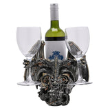 Steampunk Skull & Dragon resin wine and glass holder in silver, with a winged dragon over a gear-eyed skull cradling a bottle and two wine glasses on a white background.