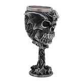 Resin goblet glass with a silver finish, featuring a bat-topped skull design, bat wings around the cup, a twisted stem, and a bat-detailed round foot, shown on a plain white background.