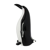 Tall glass penguin figurine with black back and beak, white front, and clear glass flippers, standing upright on a plain white background.