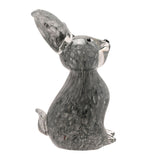 Floppy Eared Sitting Rabbit glass figurine in flecked smoky grey, one ear upright and one curled, black eyes and nose, short tail, on a plain white background.