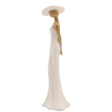 Standing Lady in Wide Hat resin figurine shown in profile, cream strapless gown flaring at the hem with natural wood-effect hair and arms, set against a plain white background.