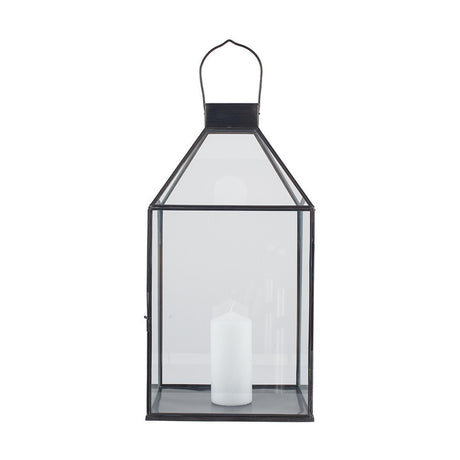 Antique Brass & Glass Lantern, 49cm, with pointed roof, hinged door and top handle, holding a white pillar candle, shown on a plain white background.