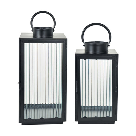 Set of 2 black iron candle lanterns with ribbed glass panels and top handles, in tall and short sizes, shown on a plain white background.