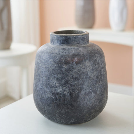 Vulcan Grey Volcanic Effect Stoneware Vase, 20cm, rounded body with narrow neck and mottled grey finish, shown on a table in a living room setting.