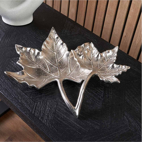 Silver Aluminium Dual Leaf Bowl - 36cm, a maple leaf-shaped decorative dish in polished silver metal, displayed on a dark wood console table.