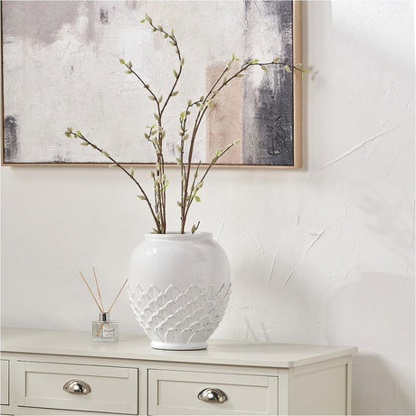 Willow White Leaf Detail Stoneware Vase, 31cm, in white ceramic with a textured lower band, styled with willow branch stems on a light sideboard beneath a framed abstract print.