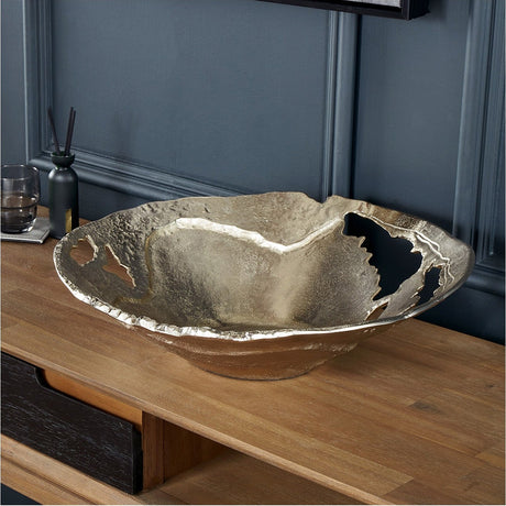 Gold Cast Aluminium Decorative Bowl, 46cm, with an organic torn-edge rim, shown on a wooden sideboard against a dark panelled wall.
