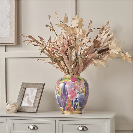 Matisse Multi Colour Ceramic Urn Vase, 29cm, with painted floral pattern and gold rim, styled with dried foliage on a sideboard beside a framed mirror.