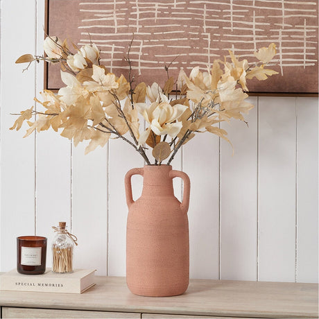 Terracotta textured vase with two side handles, 35cm, holding dried floral stems on a wooden sideboard against a white panelled wall.