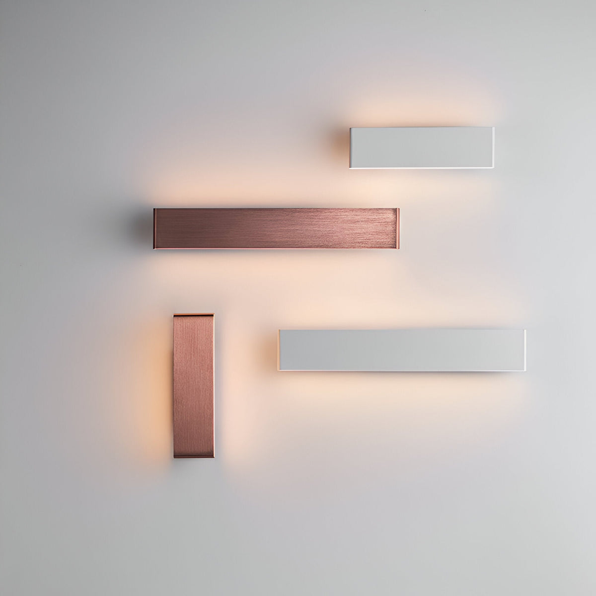 Endon Ambrose matt white LED wall lights arranged with copper-finish fittings on a pale wall, casting warm up-and-down glow in a modern layout.