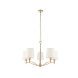 Endon Castwell 5 light pendant with vintage white faux silk shades on a matt antique brass frame, suspended from a chain on a plain white background.