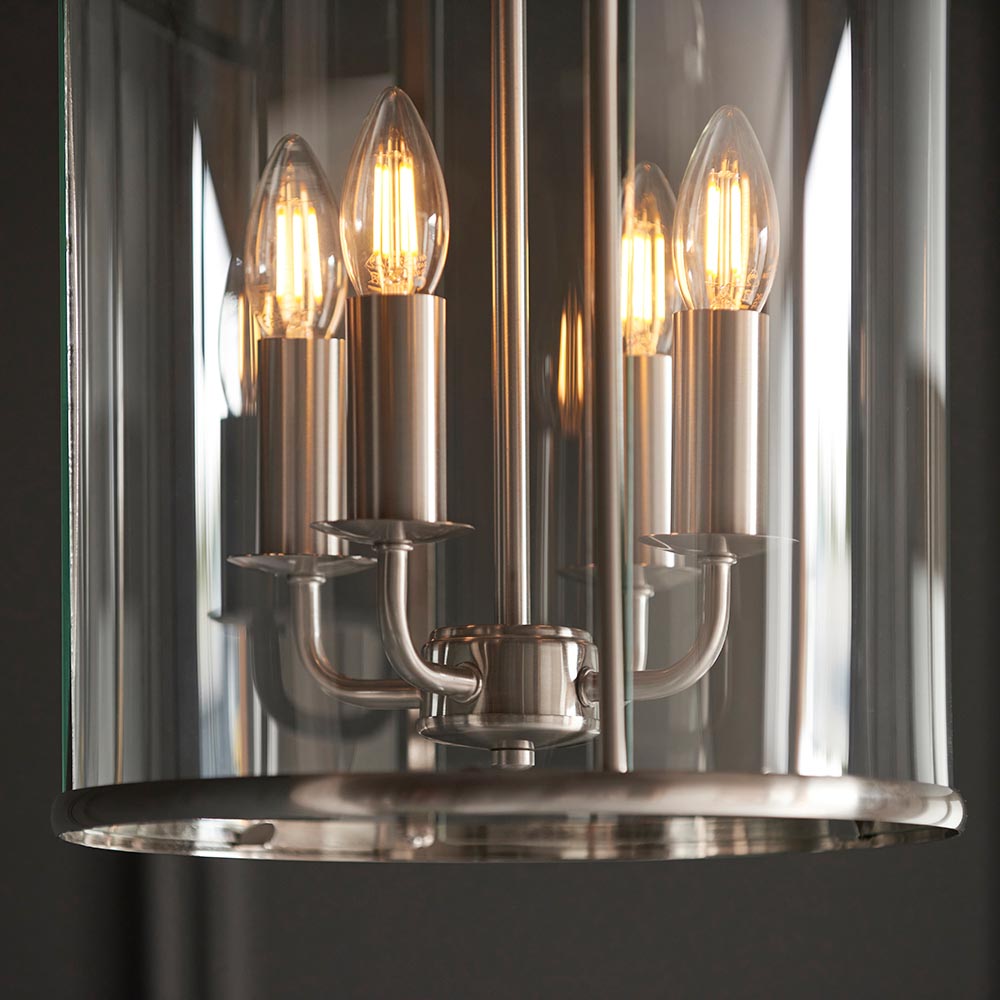 Close-up of Endon Caldbury 4 Light Pendant in nickel, showing four E14 candle lamps on slim arms within a clear glass panelled lantern frame.