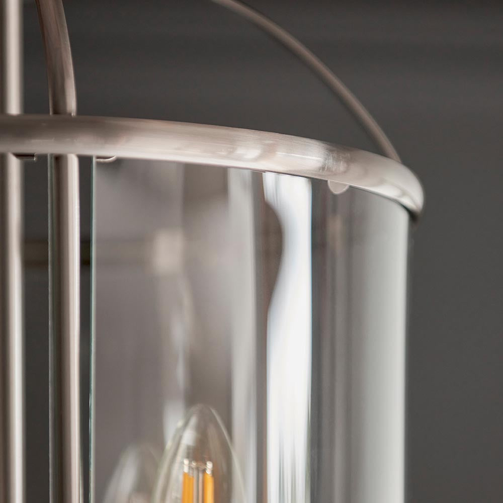 Close-up of Endon Caldbury 4 light pendant showing satin nickel frame, curved clear glass panels, and an E14 candle lamp visible inside.