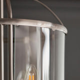 Close-up of Endon Caldbury 4 light pendant showing satin nickel frame, curved clear glass panels, and an E14 candle lamp visible inside.