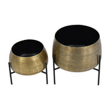 Libra Interiors Etched Brass Set of 2 Standing Planters in two sizes, with cross-hatched brass-finish iron bowls on slim black metal legs.