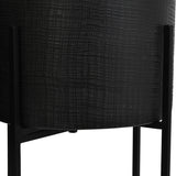 Close-up of Libra Interiors Etched Iron Floor Standing Planter in matt black, showing the cross hatch textured iron pot held in a slim four leg stand.