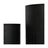 Close-up of Libra Interiors Etched Iron floor standing planters in matt black, showing the cross hatch textured surface on two cylindrical iron pots.