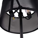 Close-up of the Libra Interiors Mesh Shade Iron Floor Lamp in black, showing two exposed filament bulbs inside the perforated drum shade and central stem.