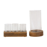 Libra Interiors Glass & Ribbed Wood Candle Holder set with three votive glasses on a rectangular base and a tall hurricane glass on a rounded grooved base.