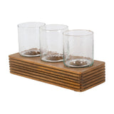 Libra Interiors Glass & Ribbed Wood Candle Holder with three clear tumbler votives set in a row along a grooved natural wood base.