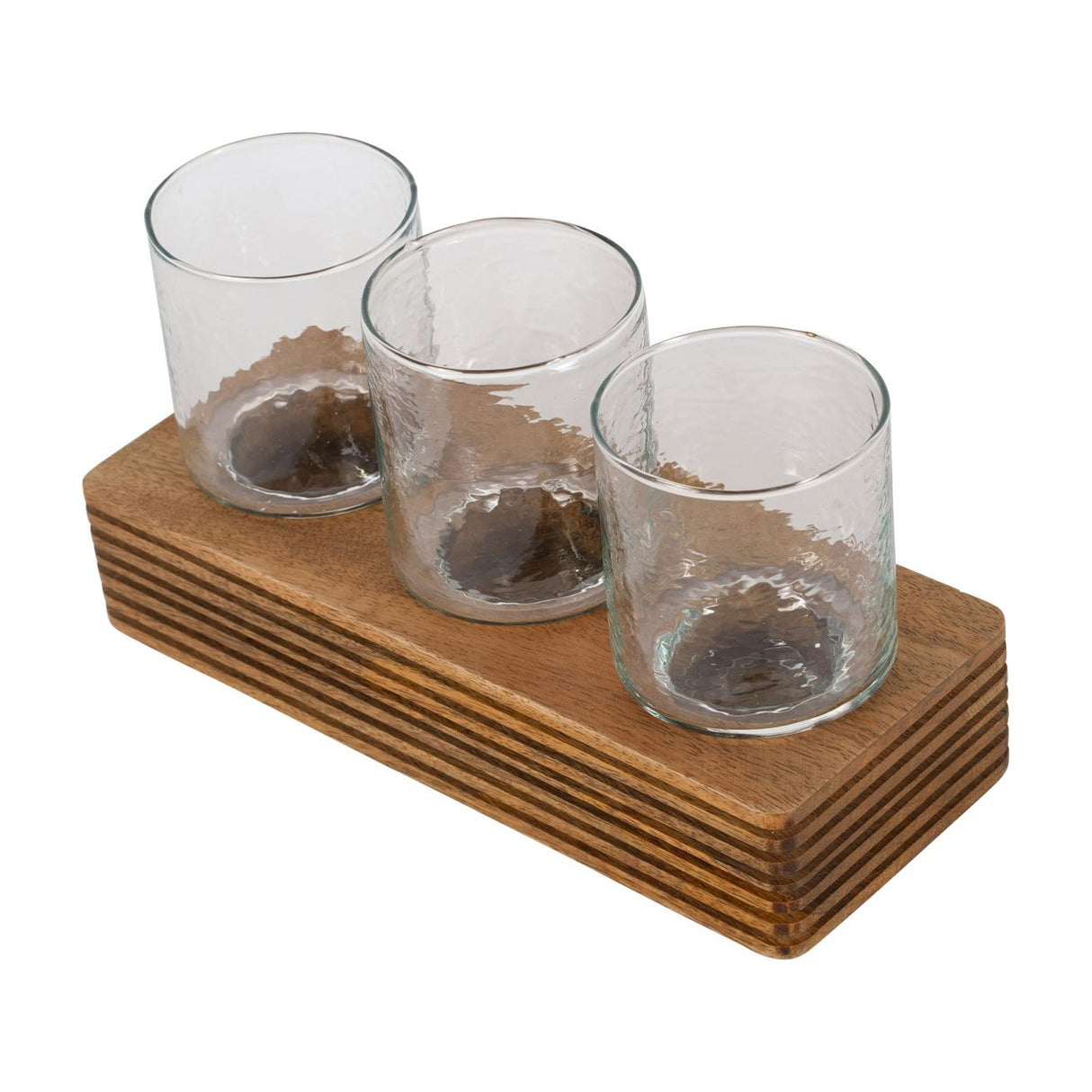 Libra Interiors Glass & Ribbed Wood Candle Holder with three clear tumbler votives set in a row on a grooved natural wood base, on a white background.