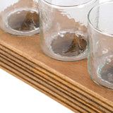 Close-up of the Libra Interiors Glass & Ribbed Wood Candle Holder showing clear votive glasses seated in the grooved natural wood base.