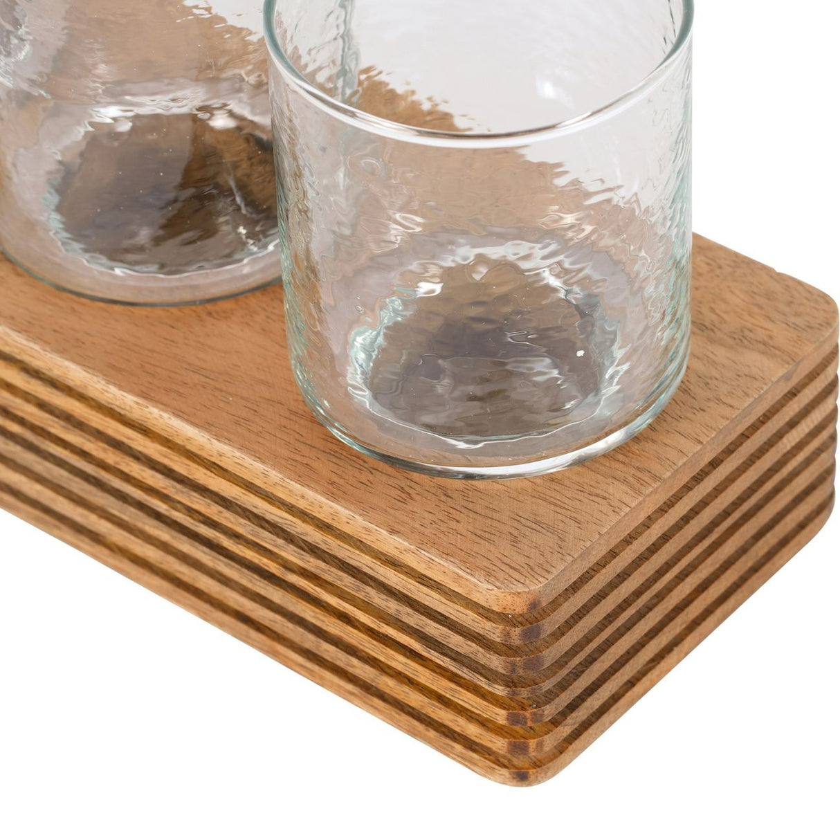 Close-up of the Libra Interiors Glass & Ribbed Wood Candle Holder, showing clear glass votives seated on a grooved natural wood base.
