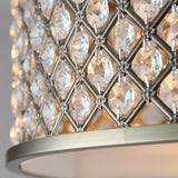 Close-up of Endon Prescott 3 Light crystal flush ceiling light showing the antique brass lattice frame set with faceted crystals and a warm glow within.