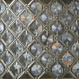 Close-up of Endon Prescott wall light showing clear crystal glass beads set in a diamond lattice steel frame with an antique brass finish.
