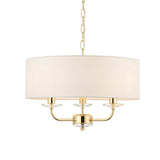 Endon Castdon 3 light pendant in brass with a wide white faux silk drum shade, three arms with K9 crystal detail, and suspension chain, on white.