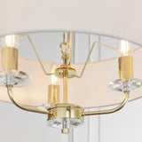 Close-up of Endon Castdon 3 Light Pendant in brass with white faux silk shade, showing K9 crystal bobeches, curved arms and E14 lamps.