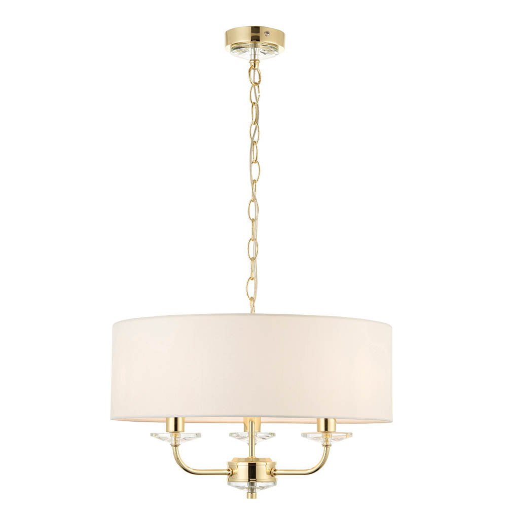 Endon Castdon 3 light pendant in brass with a wide vintage white faux silk drum shade, K9 crystal detail on three arms, and chain suspension.
