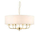 Endon Castdon 6 light pendant in brass with a large white faux silk drum shade, crystal bobeche details, and chain suspension on a white background.