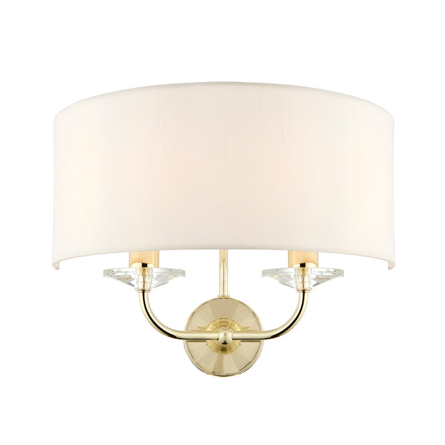 Endon Castdon 2 light wall fitting with a vintage white faux silk semi-circular shade, brass plated arms and crystal detailing on a plain background.